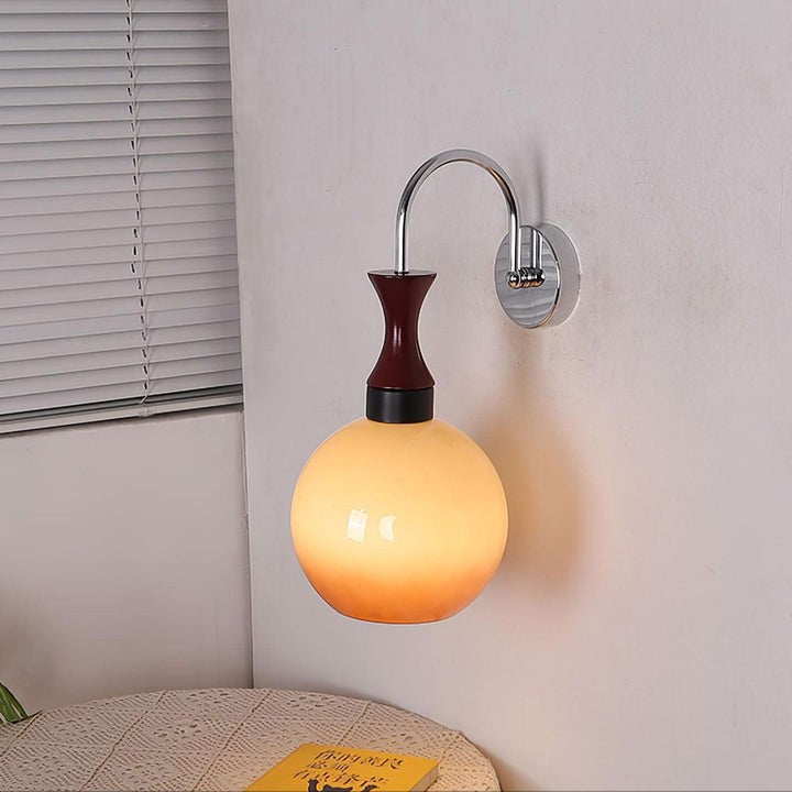 Golden Globe Wall Sconce with Sleek Metal Arm