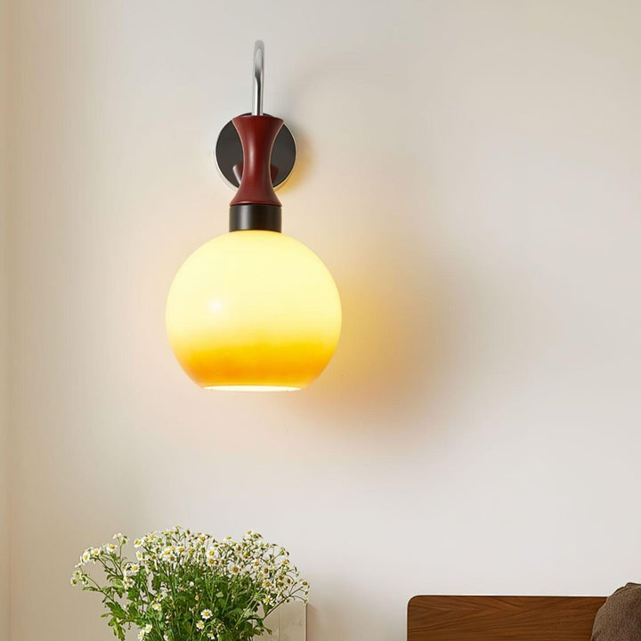 Golden Globe Wall Sconce with Sleek Metal Arm