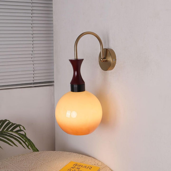 Golden Globe Wall Sconce with Sleek Metal Arm