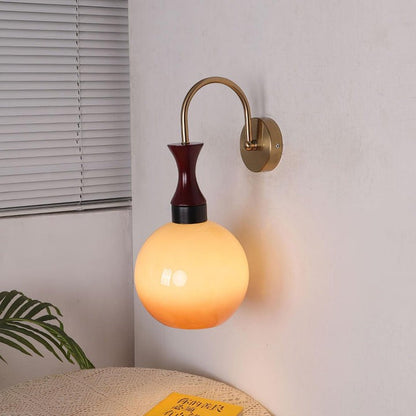 Golden Globe Wall Sconce with Sleek Metal Arm