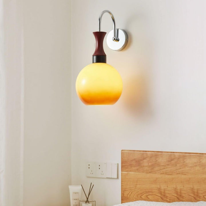 Golden Globe Wall Sconce with Sleek Metal Arm