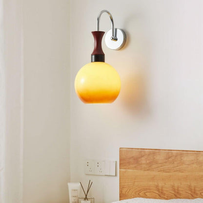 Golden Globe Wall Sconce with Sleek Metal Arm