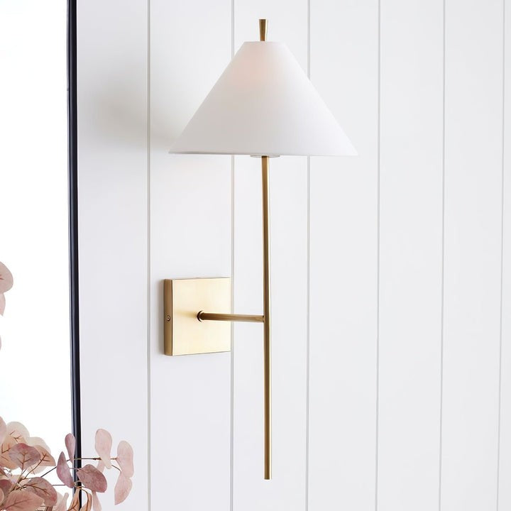 Sleek Brass Wall Sconce with White Shade & Ambient LED Lighting