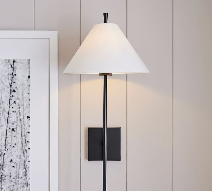Sleek Brass Wall Sconce with White Shade & Ambient LED Lighting